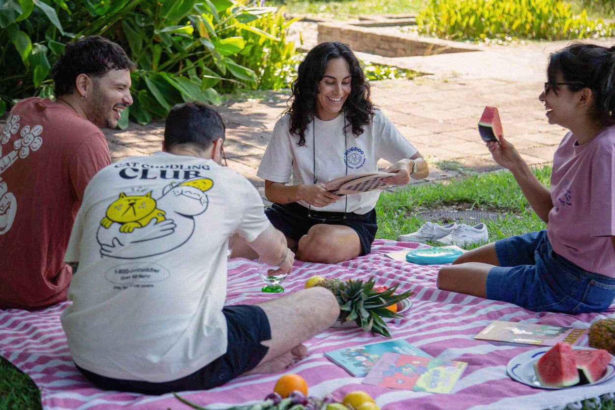 People having a picnic and eating fruit happy